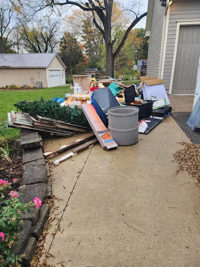 Dumpster being loaded with debris for Residential Dumpster Rental in Raymond